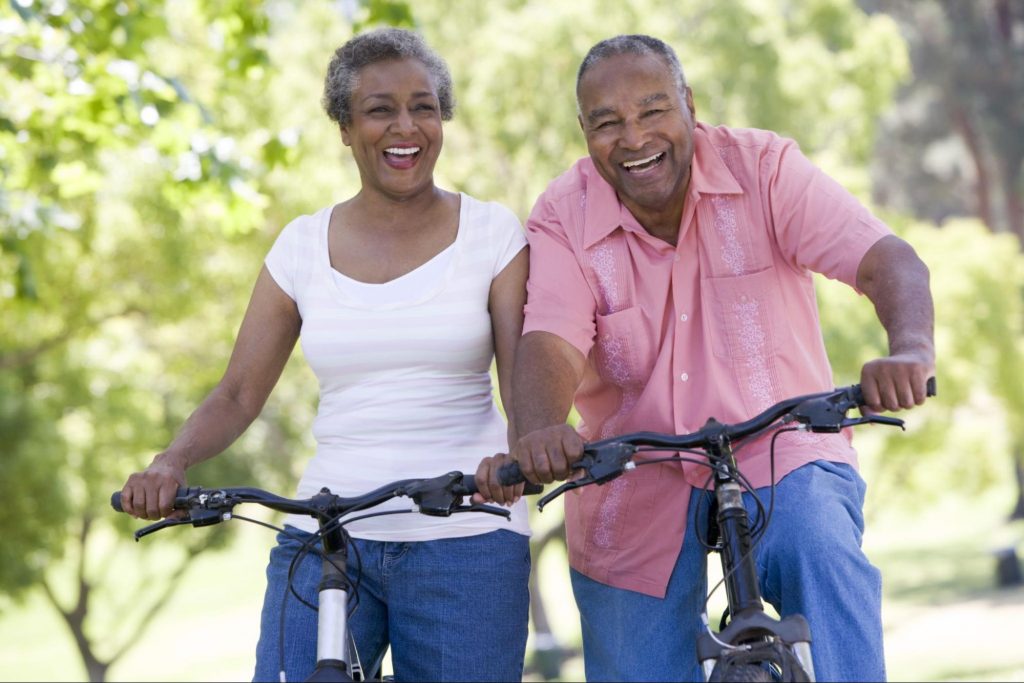 A middle age couple on a bike ride to symbolize the Connection Between Your Urologic and Heart Health